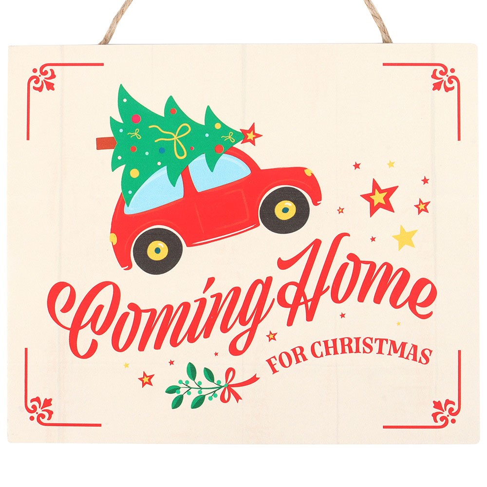 Decorative sign with a red car carrying a Christmas tree and 'Coming Home for Christmas' text on a beige background.