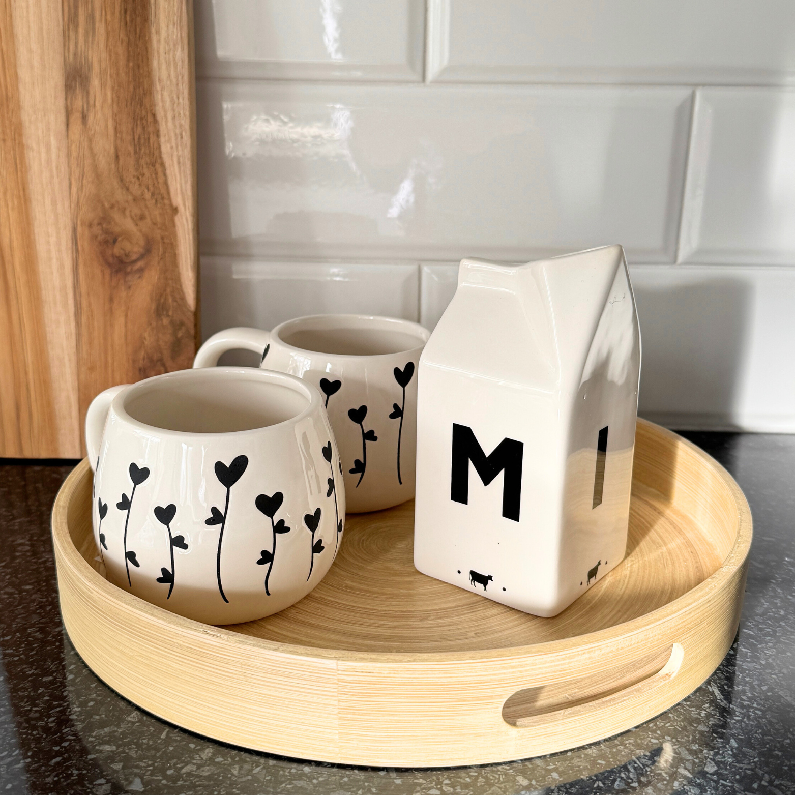 milk jug on tray with flower mugs