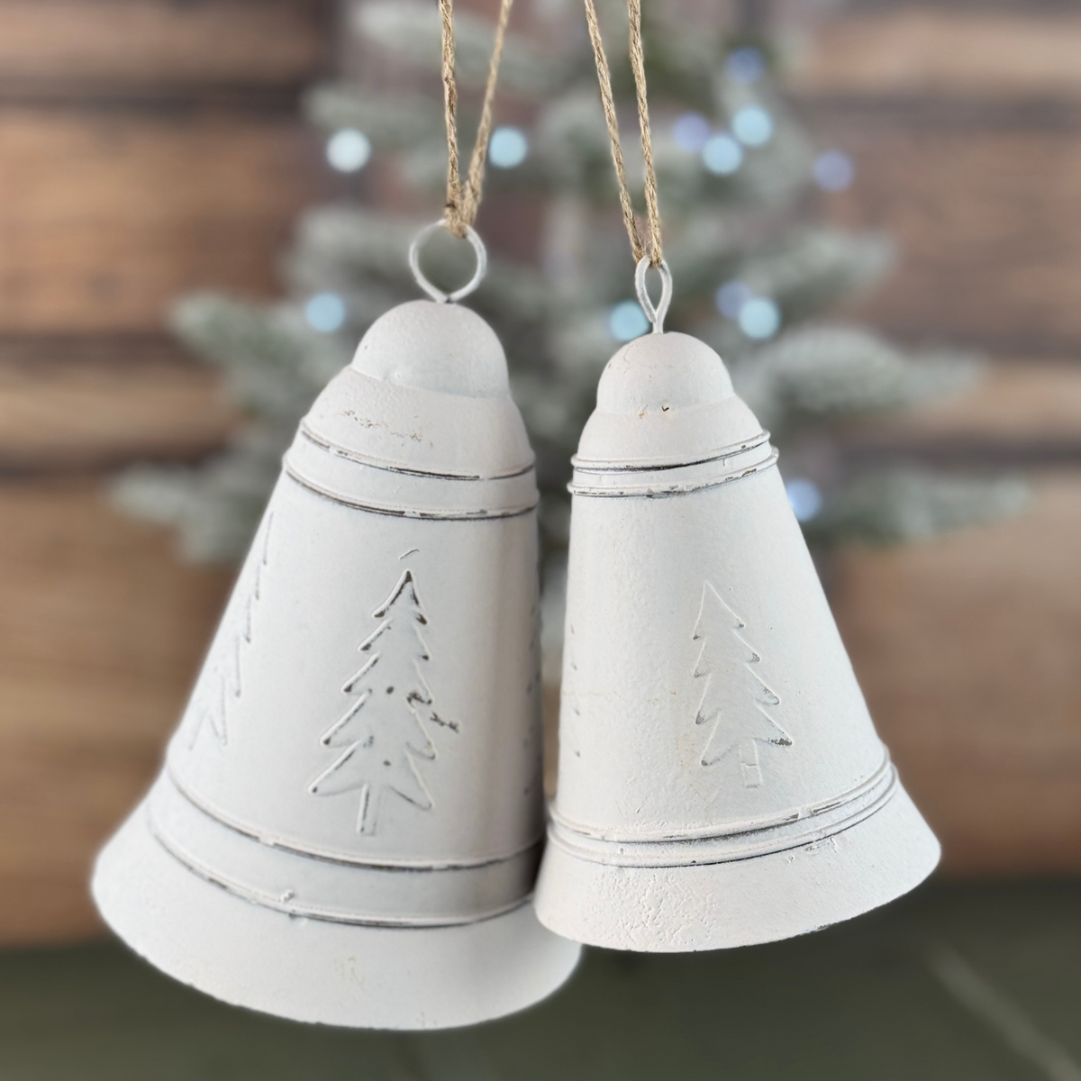 set of white bells with christmas trees on