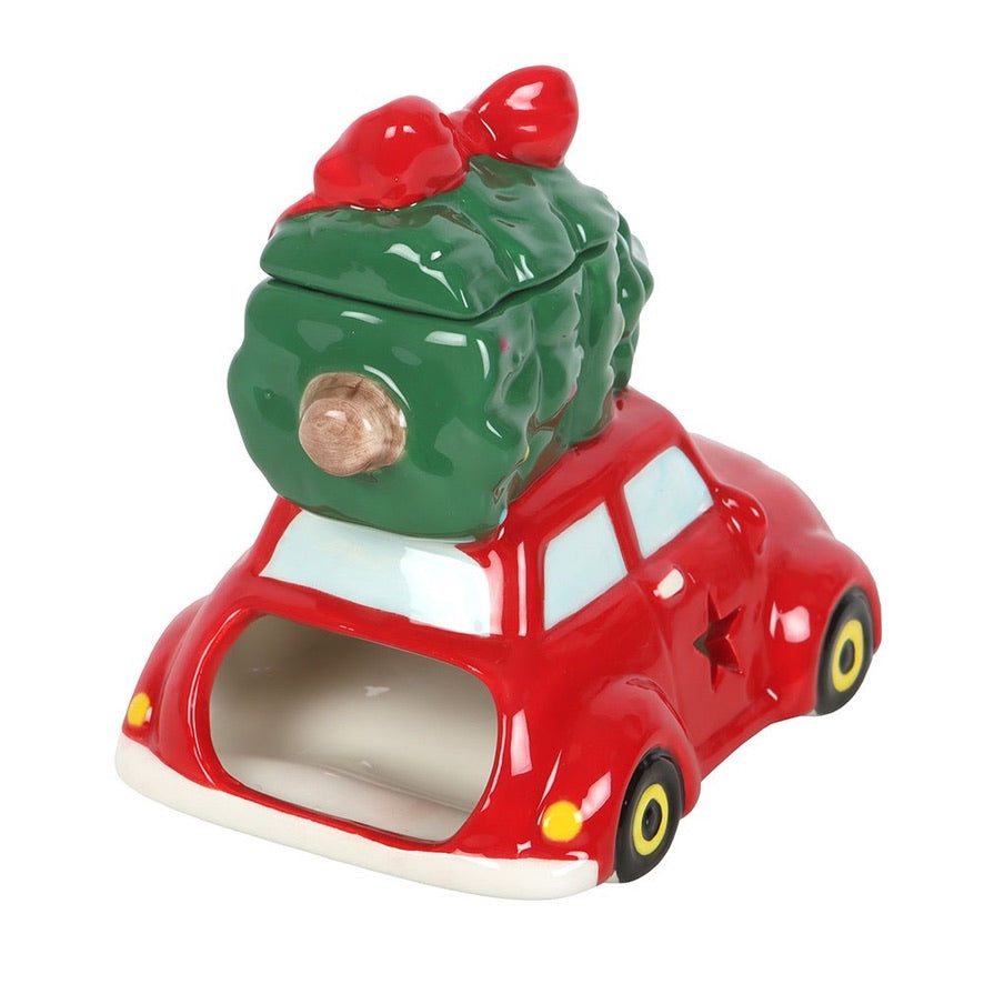 Ceramic red car with a green Christmas tree on top against a white background