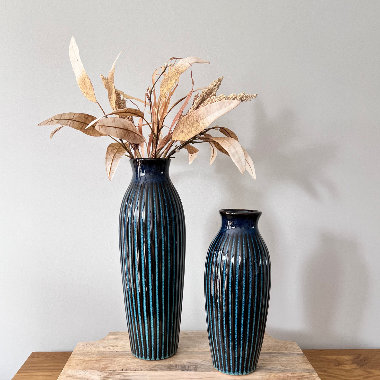 Small and large blue vases with flowers