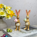 two bunnys with green and pink egg