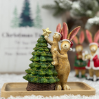 Decorative figurine of a rabbit and bunny with a Christmas tree and star.