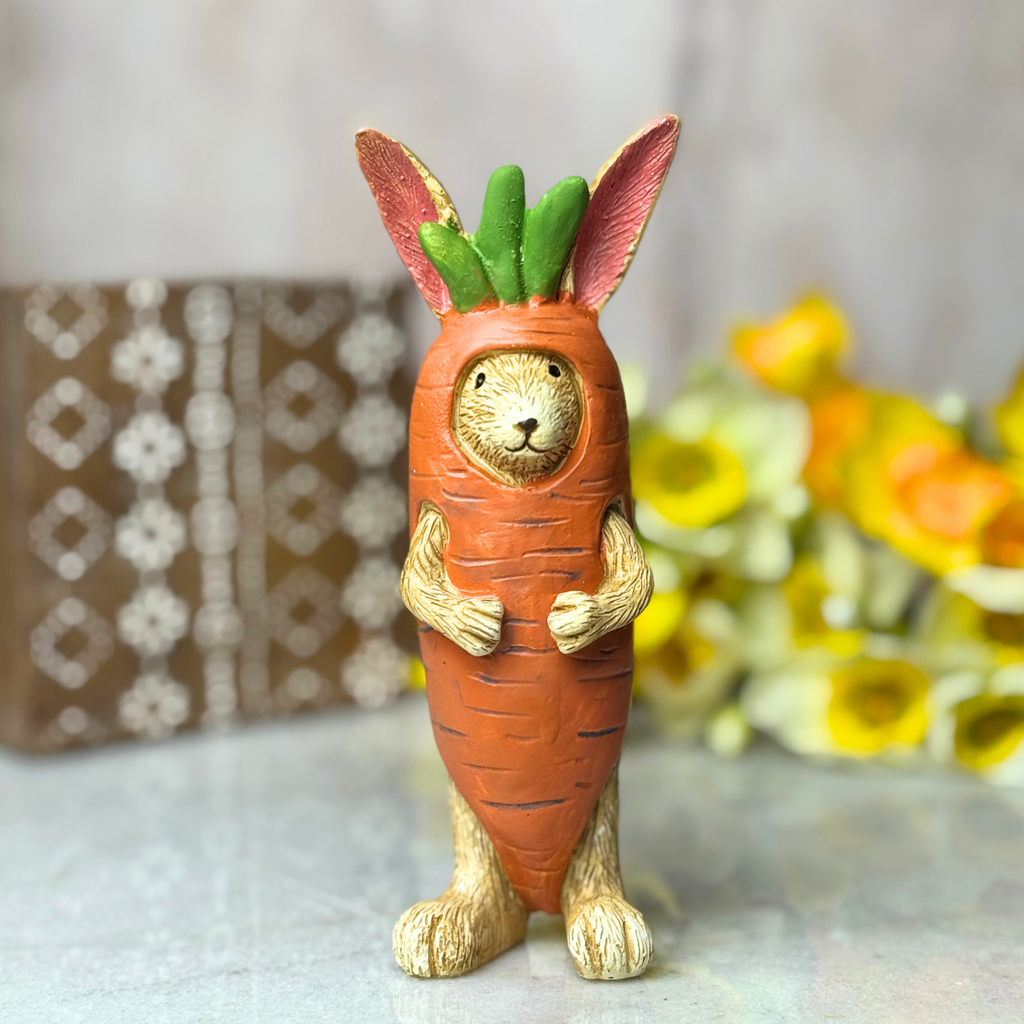Carrot-shaped figurine with rabbit ears and face on a neutral background