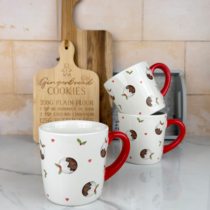 christmas pudding mug white mug with red handle and christmas pudding, holly detail