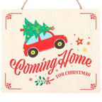 Decorative sign with a red car carrying a Christmas tree and 'Coming Home for Christmas' text on a beige background.