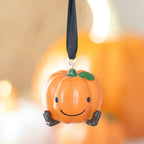 Pumpkin-shaped hanging decoration with a smiley face 
