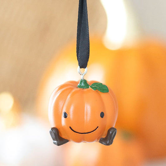 Pumpkin-shaped hanging decoration with a smiley face 