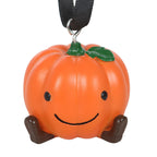 Pumpkin-shaped decoration with a smiling face on a white background