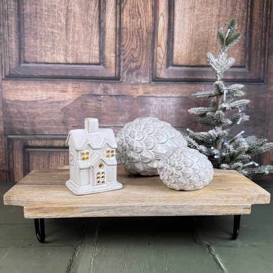 natural wooden styling board with led house and pinecones