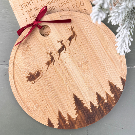 round wooden board with santa on his sleigh and festive tree