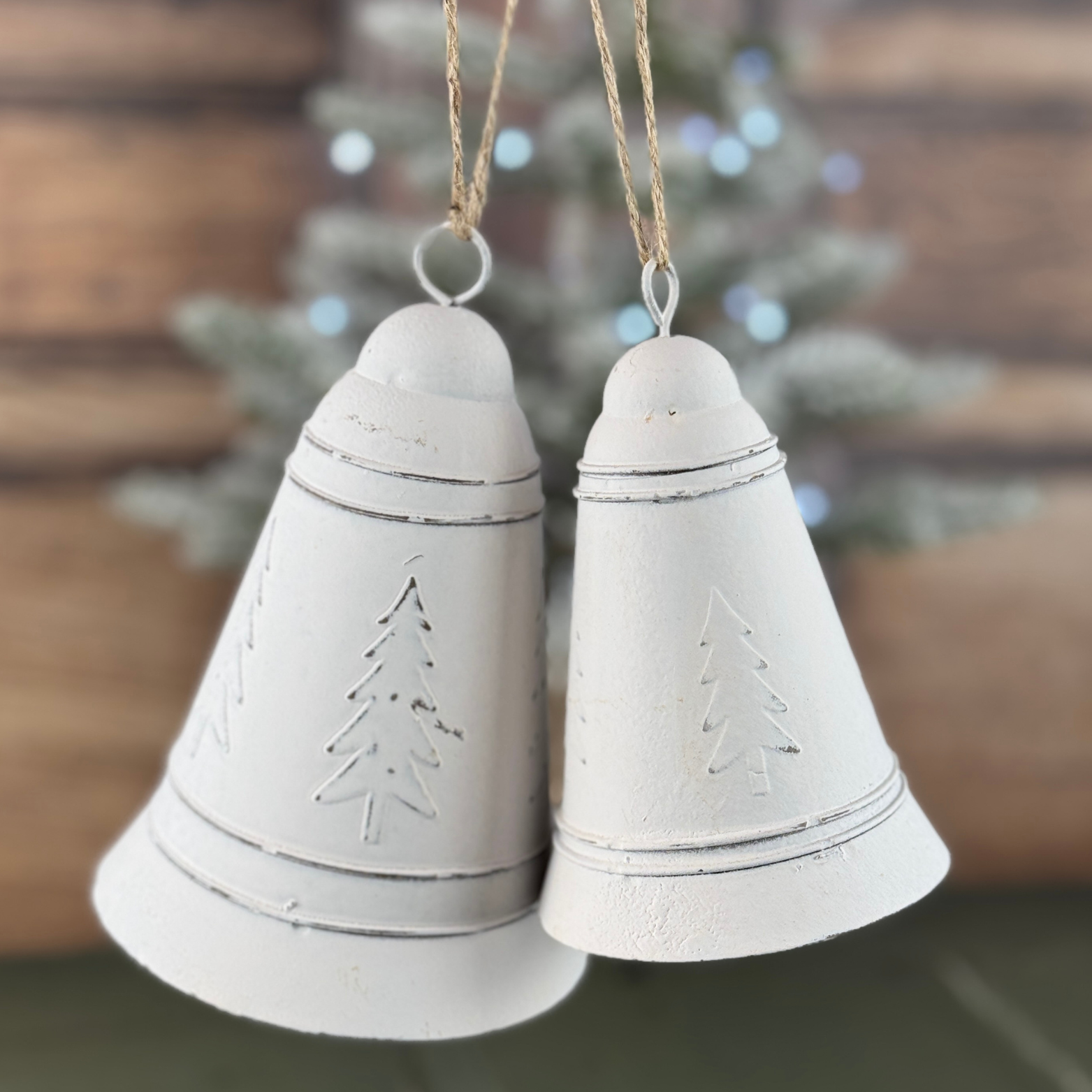 set of white bells with christmas trees on 