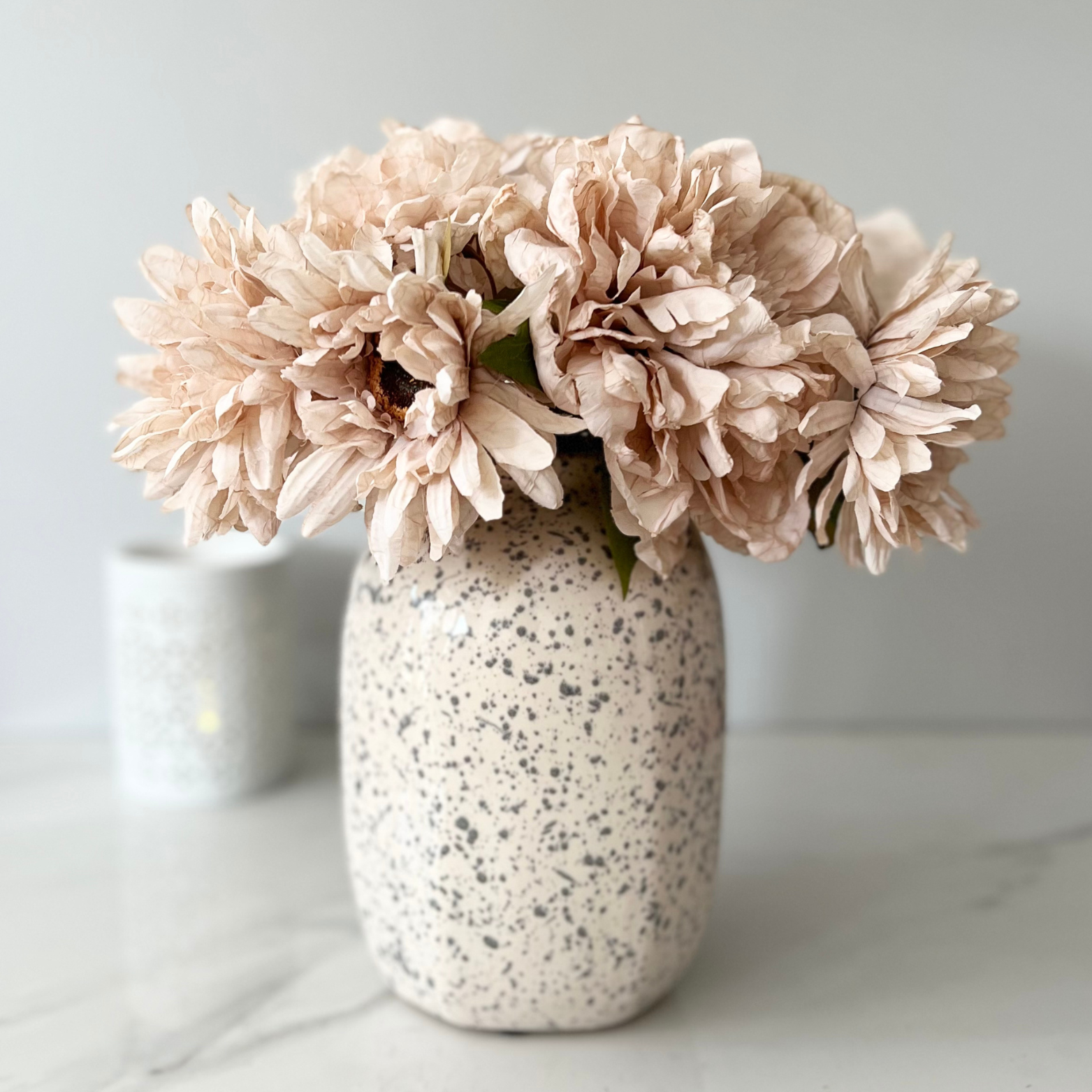 speckled vase with flowers