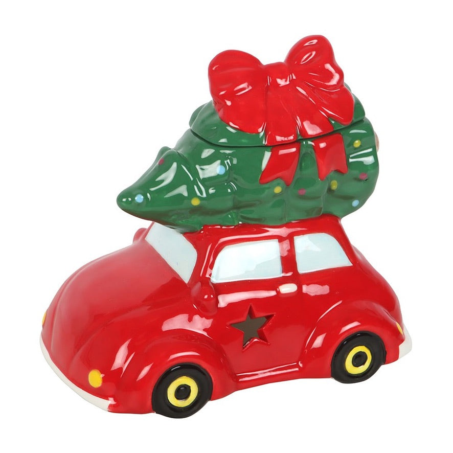 Red car with a green Christmas tree on top against a white background
