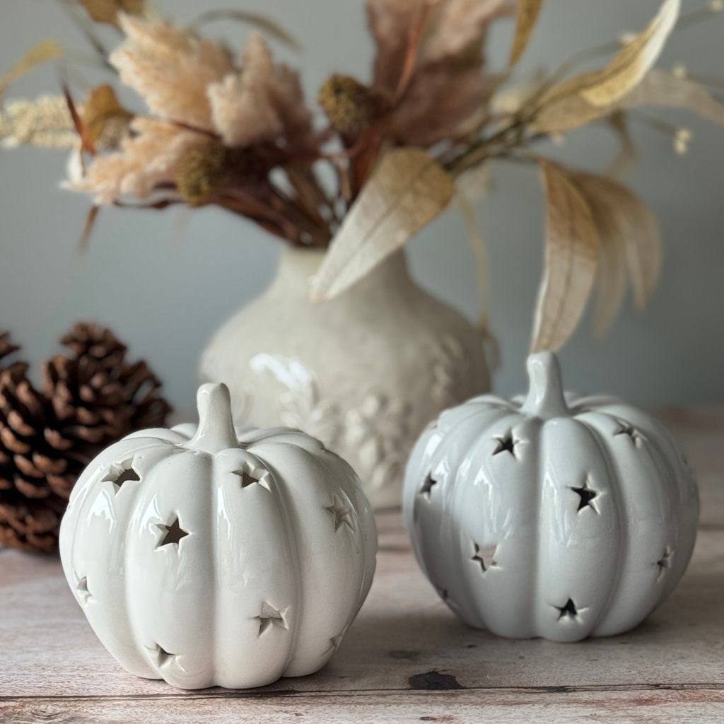 white and grey pumpkin tea light holders with star cut outs