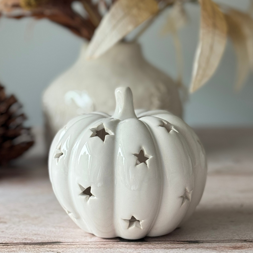 white pumpkin tea light holder with cut out stars