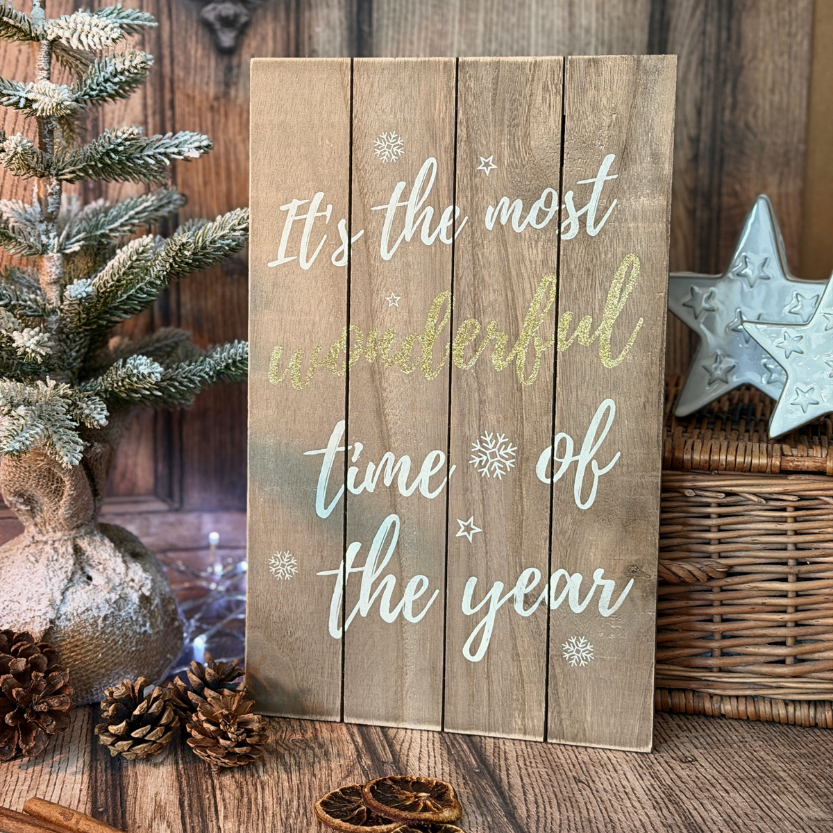 Christmas sign "It's the most wonderful time of the year" styled with Christmas foliage and fairy lights