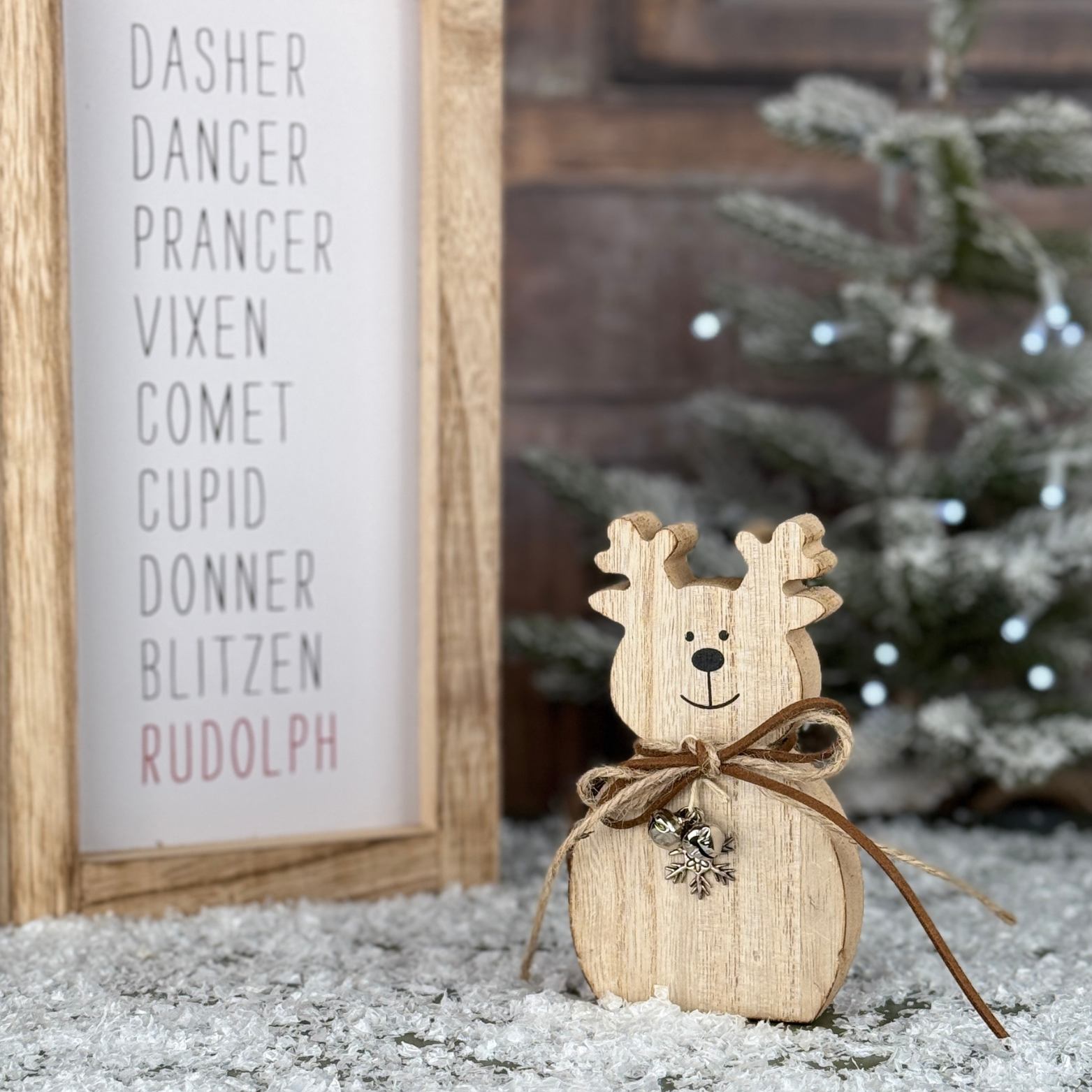 wooden reindeer with silver snowflake and bells around his neck