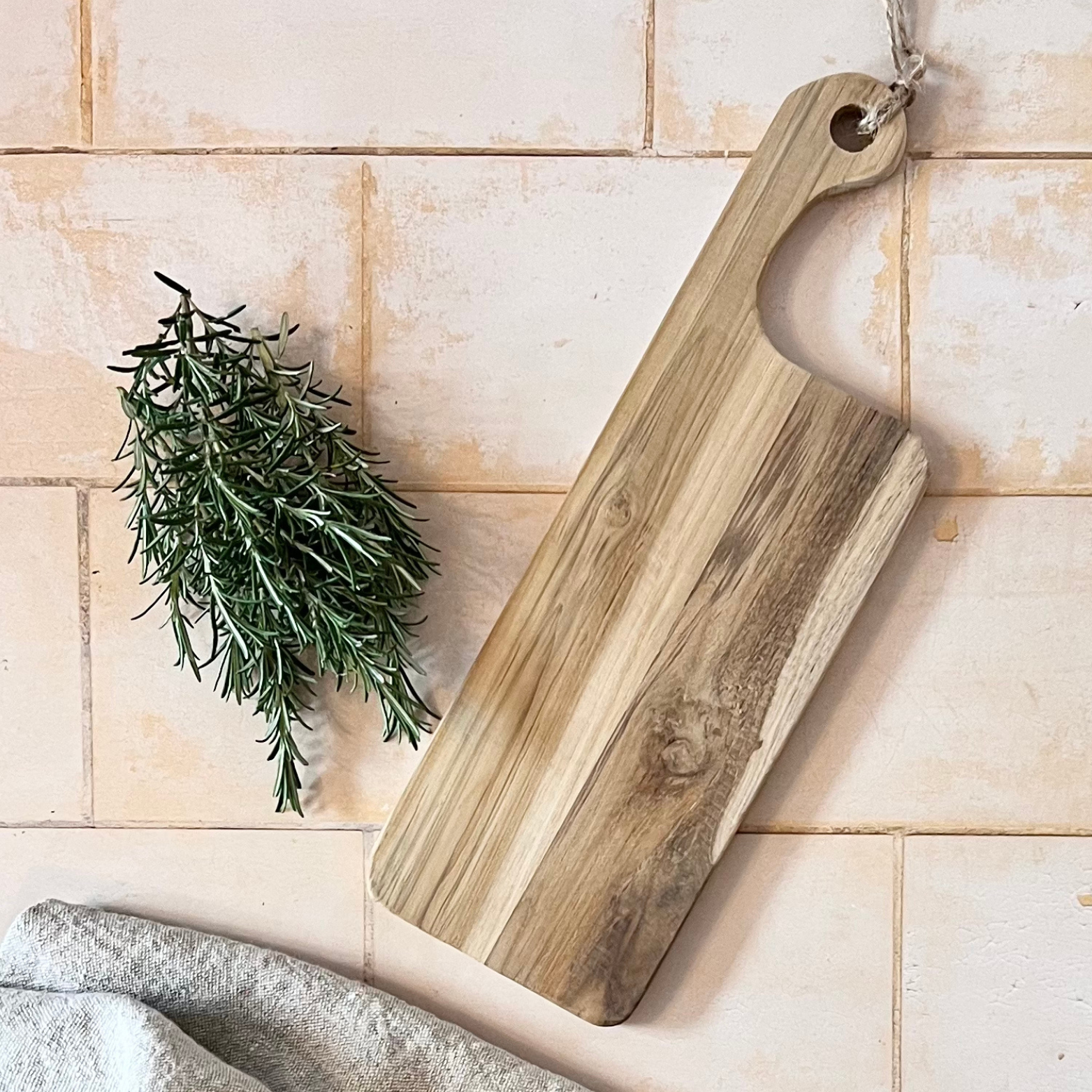 wooden serving board with rosemary